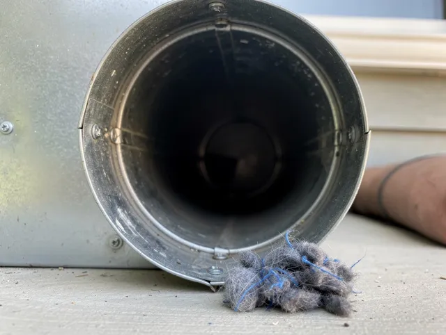 Watertown Dryer Vent Cleaning technician using specialized equipment to clear severe dryer vent blockage in Watertown
